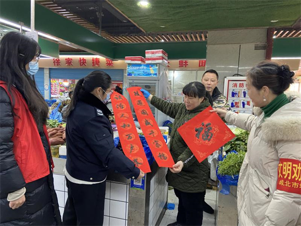 xiao图为志愿者们为周边商铺送春联图片1.jpg xiao图为志愿者们为周边商铺送春联图片1.jpg